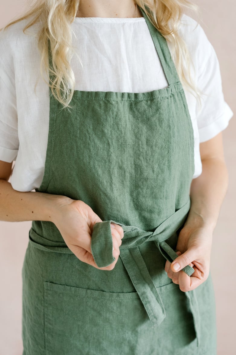 Close-Up Shot of a Woman Wearing Her Green Apron